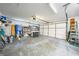 Spacious garage with ample storage, shelving, and a large garage door, perfect for projects and parking at 196 Lecturn St, Port Charlotte, FL 33954