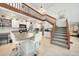 This modern kitchen features a breakfast bar and an adjacent staircase leading to the loft at 196 Lecturn St, Port Charlotte, FL 33954