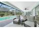 Relaxing screened-in lanai with a pool, comfortable seating, and lush landscaping at 196 Lecturn St, Port Charlotte, FL 33954