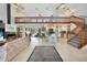 Bright, open living space with soaring ceilings, fireplace, and staircase leading to second level loft at 196 Lecturn St, Port Charlotte, FL 33954