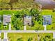 Aerial view features a home with pool with mature trees in a desirable neighborhood near a waterway at 23 Pine Valley Ct, Rotonda West, FL 33947