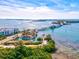 Stunning aerial view of bridge over tranquil waters with lush greenery and coastal buildings at 23 Pine Valley Ct, Rotonda West, FL 33947
