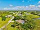 Aerial view shows landscaped neighborhood featuring serene lakes and mature trees at 23 Pine Valley Ct, Rotonda West, FL 33947