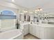 Spacious bathroom boasting a soaking tub, large mirrors, and abundant cabinet space at 23 Pine Valley Ct, Rotonda West, FL 33947