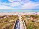 Scenic beach access point featuring a boardwalk entrance leading to a beautiful sandy shore at 23 Pine Valley Ct, Rotonda West, FL 33947