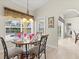 Cozy breakfast nook with a round table set for a meal and a view of the backyard pool at 23 Pine Valley Ct, Rotonda West, FL 33947