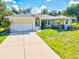 Charming single-Gathering home with well-manicured lawn and attached two-car garage at 23 Pine Valley Ct, Rotonda West, FL 33947