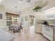 Light and airy kitchen flowing into the dining area with a view of the backyard and swimming pool at 23 Pine Valley Ct, Rotonda West, FL 33947