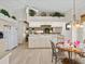 Bright, open kitchen with vaulted ceilings, white cabinets, and a breakfast nook overlooking the backyard at 23 Pine Valley Ct, Rotonda West, FL 33947