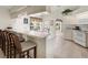 Bright kitchen with breakfast bar, white cabinets, and stainless steel appliances at 23 Pine Valley Ct, Rotonda West, FL 33947