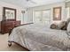Charming bedroom with a plush bed, dresser, and serene natural light streaming through windows at 23 Pine Valley Ct, Rotonda West, FL 33947
