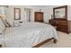 Relaxing bedroom featuring neutral colors, a plush bed, and matching dresser at 23 Pine Valley Ct, Rotonda West, FL 33947
