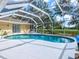 Private in-ground pool with a screened enclosure, perfect for relaxation and recreation at 23 Pine Valley Ct, Rotonda West, FL 33947