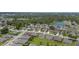 An aerial view of a charming residential community with lush landscaping and a tranquil pond at 237 Park Forest Blvd, Englewood, FL 34223