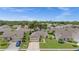 Aerial view of a single-story home with an attached garage, well-manicured lawn, and mature trees at 237 Park Forest Blvd, Englewood, FL 34223