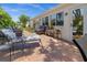 This brick paved back patio has comfortable seating, views of the lush landscaping, and a tranquil atmosphere at 237 Park Forest Blvd, Englewood, FL 34223