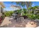 Enjoy this outdoor patio, complete with a grill, table, chairs, umbrella, and lush landscaping at 237 Park Forest Blvd, Englewood, FL 34223