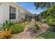 The backyard features a rock garden with stone pavers leading to a patio with outdoor seating at 237 Park Forest Blvd, Englewood, FL 34223