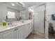 Bright bathroom with double sinks, tile flooring, and a glass-enclosed shower at 237 Park Forest Blvd, Englewood, FL 34223