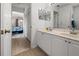 Bathroom with double sinks, tile floor and doorway leading to main bedroom at 237 Park Forest Blvd, Englewood, FL 34223