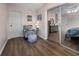 Bedroom featuring wood floors, mirrored closet doors and comfortable chair at 237 Park Forest Blvd, Englewood, FL 34223