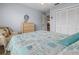 This bedroom is decorated with a dresser, closet and wicker chair for a stylish and functional living space at 237 Park Forest Blvd, Englewood, FL 34223