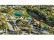 Aerial view showcases the community pool, tennis courts, and recreation area surrounded by lush landscaping at 237 Park Forest Blvd, Englewood, FL 34223