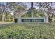 Community entrance sign surrounded by mature trees and manicured landscaping at 237 Park Forest Blvd, Englewood, FL 34223