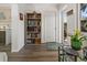 This entryway is clean and bright, featuring a bookshelf and view of the outdoors from a glass-paneled door at 237 Park Forest Blvd, Englewood, FL 34223