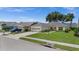 This single-story home has an attached garage, well-manicured lawn, and mature trees at 237 Park Forest Blvd, Englewood, FL 34223