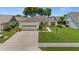 Charming single-story home featuring a well-manicured lawn, attached garage, and inviting curb appeal at 237 Park Forest Blvd, Englewood, FL 34223