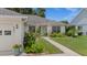 Well-manicured front yard featuring lush landscaping and a charming walkway leading to the entrance at 237 Park Forest Blvd, Englewood, FL 34223