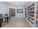 Cozy library featuring floor-to-ceiling bookshelves and a comfortable reading area at 237 Park Forest Blvd, Englewood, FL 34223
