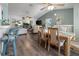 Bright open-concept living and dining area featuring vaulted ceilings, wood floors, and lots of natural light at 237 Park Forest Blvd, Englewood, FL 34223