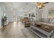 Inviting living area with an open layout, wood-look floors, and views of the dining and kitchen areas at 237 Park Forest Blvd, Englewood, FL 34223
