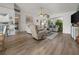 Open living room with neutral tones, wood-look floors, and a view to the Florida room at 237 Park Forest Blvd, Englewood, FL 34223