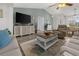 Spacious living room with a vaulted ceiling, a large television, and stylish coastal decor at 237 Park Forest Blvd, Englewood, FL 34223