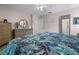 Bedroom featuring light pink walls, wood floors, large dresser and a comfortable bed at 237 Park Forest Blvd, Englewood, FL 34223
