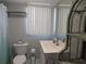 The bathroom features a vanity, toilet, and shelves for organized storage at 2373 N Beach Rd # 1C, Englewood, FL 34223