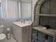 Bright bathroom features a vanity, mirror, and storage shelves with fresh towels at 2373 N Beach Rd # 1C, Englewood, FL 34223