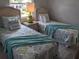 Bright bedroom with twin beds, beach-themed decor and light at 2373 N Beach Rd # 1C, Englewood, FL 34223