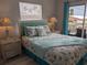 Comfortable bedroom with coastal decor and access to outdoor balcony at 2373 N Beach Rd # 1C, Englewood, FL 34223
