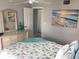 Inviting bedroom with coastal decor, dresser, and artwork at 2373 N Beach Rd # 1C, Englewood, FL 34223