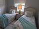 Charming bedroom with twin beds, beach-themed decor and bright natural light at 2373 N Beach Rd # 1C, Englewood, FL 34223