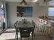 Charming dining area with modern lighting fixture near the kitchen and balcony access at 2373 N Beach Rd # 1C, Englewood, FL 34223