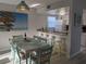 Open dining and kitchen area featuring a casual bar and natural light at 2373 N Beach Rd # 1C, Englewood, FL 34223