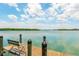 Scenic view from the wood dock with bench seating, perfect for enjoying the waterfront at 2373 N Beach Rd # 1C, Englewood, FL 34223