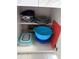 Kitchen cabinet featuring mixing bowls, plastic storage containers and accessories at 2373 N Beach Rd # 1C, Englewood, FL 34223