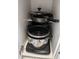 Kitchen cabinet featuring various pots and pans for cooking needs at 2373 N Beach Rd # 1C, Englewood, FL 34223