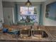 Stainless steel sink with modern fixtures, enhancing the kitchen's appeal and functionality at 2373 N Beach Rd # 1C, Englewood, FL 34223